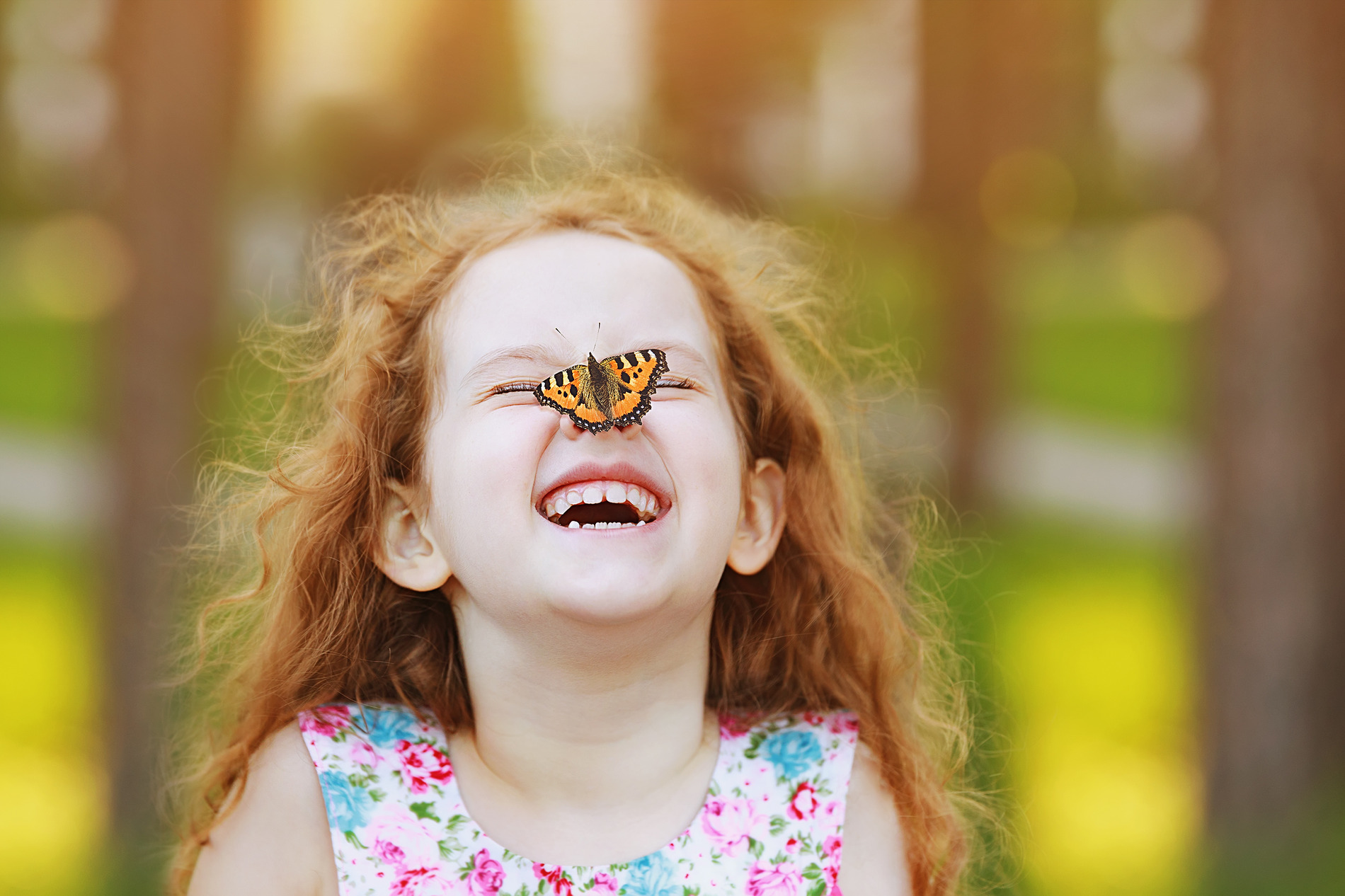 Happy little girl playing with a butterfly after pediatric dental care in Chesterfield MO