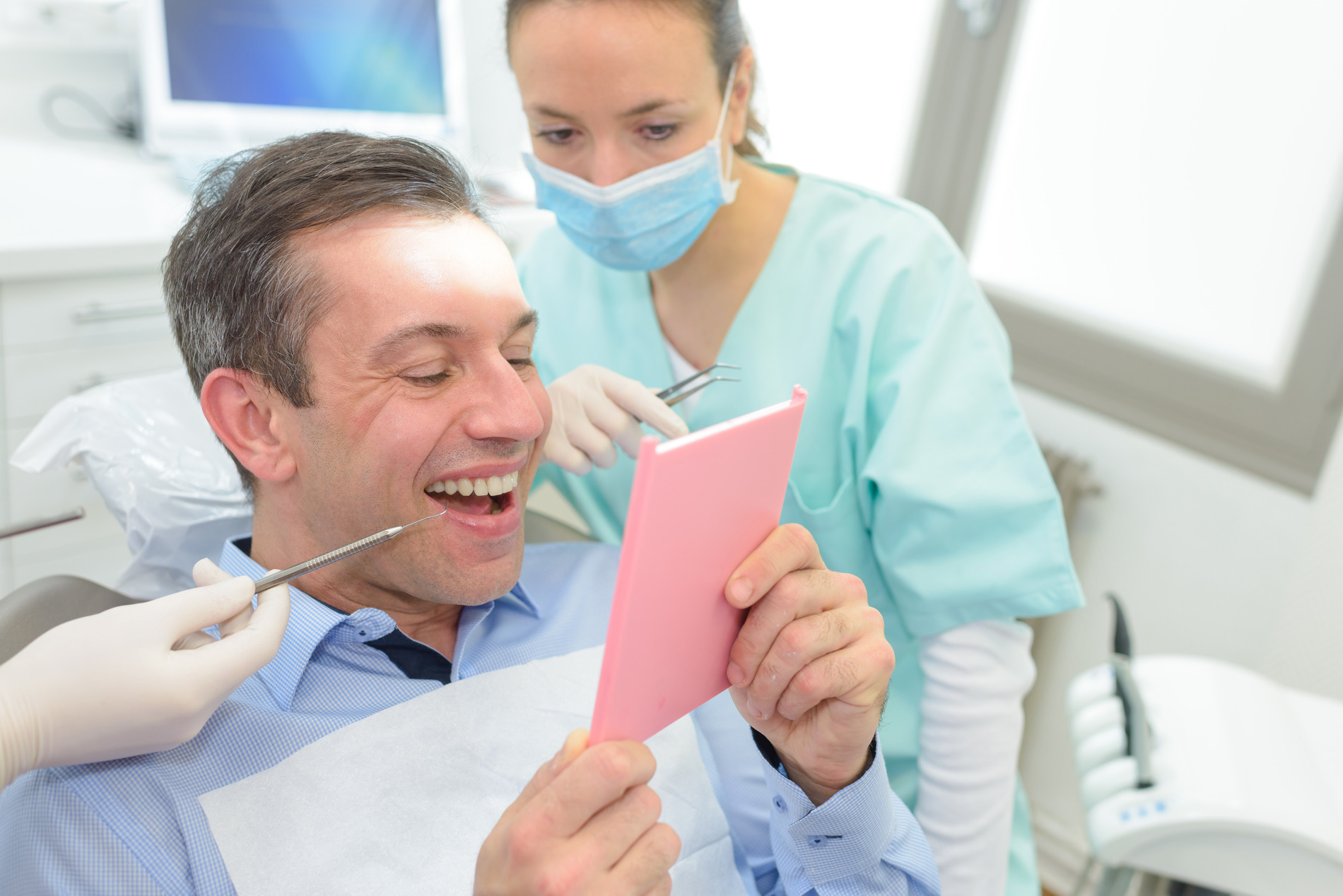 AdobeStock_196499720 v2 Man talking to Dr. Esmailzadegan at his dental bridge appointment in Chesterfield MO