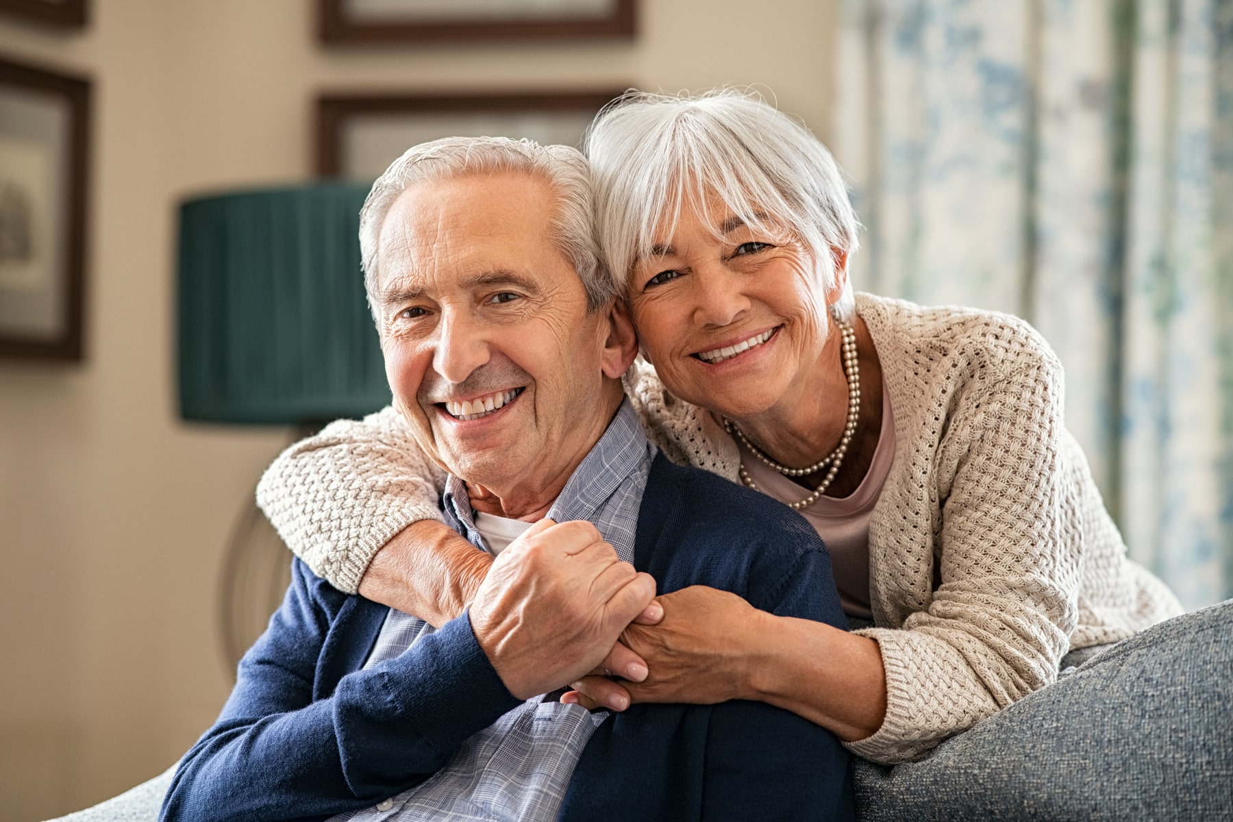 Implants2_AdobeStock_434943635_1800x1200-min patients smiling after getting their dental implants from Chesterfield Dental Studio in Chesterfield MO